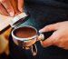 close-up-hand-barista-cafe-making-coffee-with-manual-presses-ground-coffee-using-tamper_51137-5454